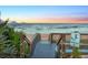 Wooden boardwalk leads to sandy beach with ocean view at 3580 Ocean Shore Blvd, Ormond Beach, FL 32176