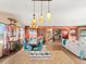 Spacious dining area with glass-top table and teal chairs, adjacent to kitchen at 3580 Ocean Shore Blvd, Ormond Beach, FL 32176