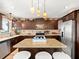 Well-equipped kitchen with ample cabinetry, granite countertops, and island seating at 3580 Ocean Shore Blvd, Ormond Beach, FL 32176