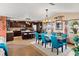 Bright kitchen and dining space featuring a large island and teal chairs at 3580 Ocean Shore Blvd, Ormond Beach, FL 32176