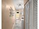 Hallway with wood-look flooring, access to laundry and other rooms at 3580 Ocean Shore Blvd, Ormond Beach, FL 32176