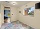Bright office space with large window, view, and sea-themed rug at 3580 Ocean Shore Blvd, Ormond Beach, FL 32176