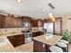 Updated kitchen boasts dark wood cabinets, granite countertops and stainless steel appliances at 3580 Ocean Shore Blvd, Ormond Beach, FL 32176