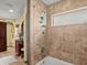 Bathroom with shower/tub combo, tile surround, vanity with dark wood, and decorative accents at 3580 Ocean Shore Blvd, Ormond Beach, FL 32176