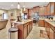 Updated kitchen featuring wood cabinets, granite countertops, and stainless steel appliances at 605 Champions Gate, Deland, FL 32724