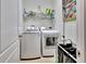 Bright laundry room with washer, dryer, and ample storage at 605 Champions Gate, Deland, FL 32724