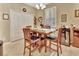Charming dining area with wood table and chairs, adjacent to kitchen at 605 Champions Gate, Deland, FL 32724