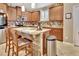 Modern kitchen with granite countertops, stainless steel appliances, and an island with seating at 605 Champions Gate, Deland, FL 32724