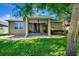 Well maintained house with a screened porch and lawn at 605 Champions Gate, Deland, FL 32724