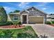 House exterior with stone accents and a paved driveway at 605 Champions Gate, Deland, FL 32724