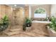 Elegant bathroom with a walk-in shower and a soaking tub at 117 Alexandra Woods Dr, Debary, FL 32713