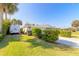 Side view of the house with a spacious yard and RV parking at 100 Talo Cir, Port Orange, FL 32127