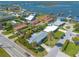 Aerial view of waterfront home with lush landscaping and nearby marina at 100 Talo Cir, Port Orange, FL 32127