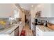 Modern kitchen with white cabinets, granite counters, and stainless steel appliances at 100 Talo Cir, Port Orange, FL 32127