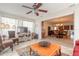 Bright sunroom features wicker furniture and view into dining room at 100 Talo Cir, Port Orange, FL 32127
