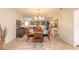 Bright dining room with a round glass table and views to living room at 100 Talo Cir, Port Orange, FL 32127
