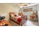 Bright bedroom with a wooden sleigh bed, dresser, and vanity at 100 Talo Cir, Port Orange, FL 32127