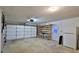 Spacious garage with ample storage shelving and extra refrigerator at 3 Wisteria Dr, Ormond Beach, FL 32176