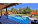 Relaxing pool area with a covered patio, lush landscaping, and comfortable seating at 3 Wisteria Dr, Ormond Beach, FL 32176