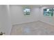 Bright bedroom with herringbone tile floor and two windows at 3 Wisteria Dr, Ormond Beach, FL 32176