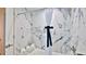 Elegant bathroom with marble walls and a white bathtub at 3 Wisteria Dr, Ormond Beach, FL 32176
