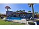 Inviting pool area with a covered patio, lush landscaping, and plenty of seating at 3 Wisteria Dr, Ormond Beach, FL 32176