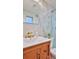 Elegant bathroom with marble tile, a modern vanity, and gold fixtures at 3 Wisteria Dr, Ormond Beach, FL 32176