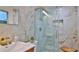Spa-like bathroom with marble tile, a glass shower, and a wooden stool at 3 Wisteria Dr, Ormond Beach, FL 32176