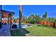 Private backyard oasis with a pool, covered patio and tropical landscaping at 3 Wisteria Dr, Ormond Beach, FL 32176