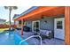 Relaxing pool area with patio furniture and covered seating at 3 Wisteria Dr, Ormond Beach, FL 32176