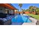 Relaxing pool with patio furniture and wooden accents at 3 Wisteria Dr, Ormond Beach, FL 32176