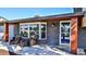 Welcoming front porch with wicker seating and a blue front door at 3 Wisteria Dr, Ormond Beach, FL 32176