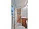 Bathroom with marble tile, a glass shower, and a view into hallway at 3 Wisteria Dr, Ormond Beach, FL 32176