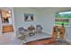Home office with two armchairs, a wooden table, and garden view at 3 Wisteria Dr, Ormond Beach, FL 32176