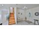 Bright and airy entryway with wood staircase and tile flooring at 3 Wisteria Dr, Ormond Beach, FL 32176