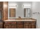 Double vanity bathroom with dark wood cabinets and granite countertop at 1978 Country Club Dr, Port Orange, FL 32128