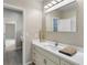 Modern bathroom with updated vanity, patterned wallpaper, and new flooring at 1978 Country Club Dr, Port Orange, FL 32128