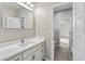 Bathroom with updated vanity, a large mirror and patterned wallpaper at 1978 Country Club Dr, Port Orange, FL 32128