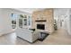 Living room with a stone fireplace, pool view, and light-colored furniture at 1978 Country Club Dr, Port Orange, FL 32128