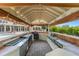 Fully equipped outdoor kitchen with stainless steel appliances under a covered patio at 1978 Country Club Dr, Port Orange, FL 32128