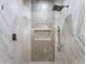 Luxurious shower with marble tile and rainfall shower head at 1978 Country Club Dr, Port Orange, FL 32128