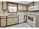 Functional kitchen featuring white appliances and wood cabinets at 41 Villa Villar Ct # 41, Deland, FL 32724