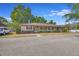 Tan house with maroon shutters and landscaping at 41 Villa Villar Ct # 41, Deland, FL 32724