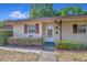 Tan house with maroon shutters and landscaping at 41 Villa Villar Ct # 41, Deland, FL 32724