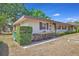 Tan house with maroon shutters and landscaping at 41 Villa Villar Ct # 41, Deland, FL 32724