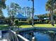 Waterfront home with expansive lawn, dock, and two structures at 24117 Mink Rd, Astor, FL 32102