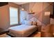 Cozy bedroom with geometric accent wall and window blinds at 226 Meghan Cir, Deland, FL 32724