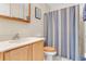 Clean bathroom with a shower/tub combo, wood vanity, and striped shower curtain at 134 Avalon Dr # A, Ormond Beach, FL 32176