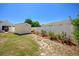 Landscaped backyard with a storage shed and a white vinyl fence providing privacy at 134 Avalon Dr # A, Ormond Beach, FL 32176