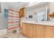 Clean bathroom with wood cabinets, a shower/tub combo, and a tiled floor at 134 Avalon Dr # A, Ormond Beach, FL 32176